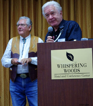 Gary Clarke accepts his “Gathering of Guns 3” award. Emcee John Buttram stands by.