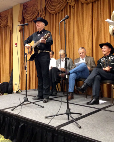 Johnny Western wound up the radio recreation with the TV theme song he wrote and sang for “Have Gun Will Travel”. Seated are Bobby Crawford, Jim Kocher, Boyd Magers and Don Quine.