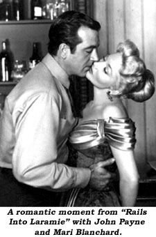 A romantic moment from "Rails Into Laramie" with John Payne and Mari Blanchard.