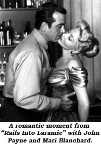 A romantic moment from "Rails Into Laramie" with John Payne and Mari Blanchard.