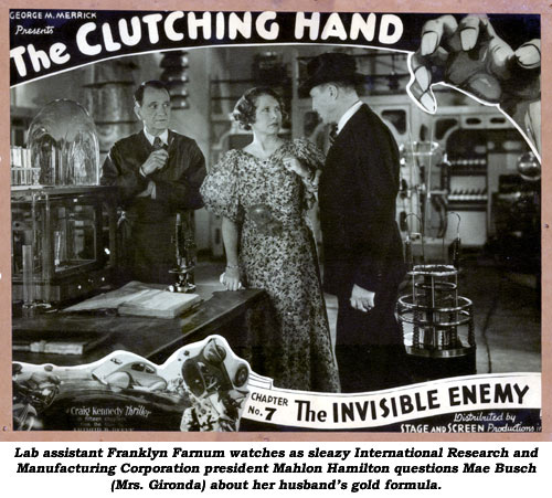 Lab assistant Franklyn Farnum watches as sleazy International Research and Manufacturing Corporation president Mahlon Hamilton questions Mae Busch (Mrs. Gironda) about her husband's gold formula.