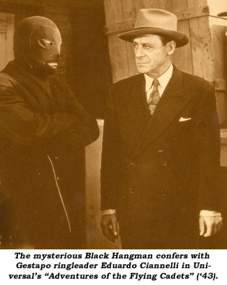 The mysterious Black Hangman confers with Gestapo ringleader Eduardo Ciannelli in Universal's "Adventures of the Flying Cadets" ('43).