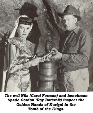 The evil Nila (Carol Forman) and henchman Spade Gordon (Roy Barcroft) inspect the Golden Hands of Kurigal in the Tomb of the Kings.