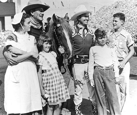 John Wayne and Gene Autry with Wayne’s children, Toni, Melinda, Patrick and Michael at the one of the annual Sheriff’s Rodeos in L.A. Colisseum. (Photo courtesy Neil Summers.)