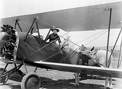 Ken Maynard and Tarzan with Ken’s private plane.