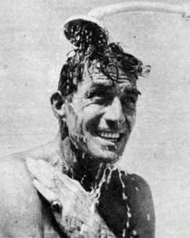 Jock in shower on beach.