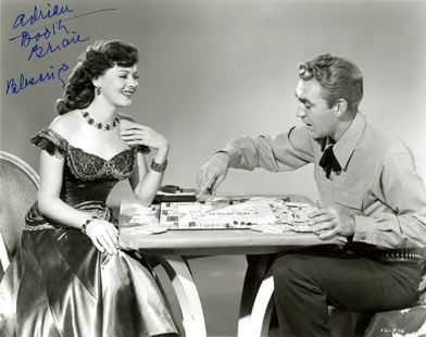 Adrian Booth and Forrest Tucker play a little game of Monopoly to relax between scenes.