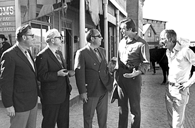 On location for the TV movie “Yuma”, star Clint Walker and producer Aaron Spelling meet with some local businessmen. 