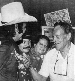 Charles "Durango Kid" Starrett checks out Sunset Carson's neck piece at the 1982 Memphis Western Film Festival. 