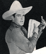 Ken Maynard with a cork-covered bent nail he uses for a towel hanger in his workshop.