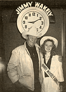 Ben Johnson poses before the infamous Jimmy Wakely clock whose hands were always set to mark the very moment Jimmy passed on. 