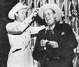 Roy Rogers adjusts the hat of radio favorite, Uncle Don.