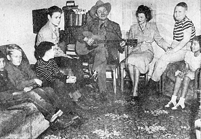 Tex Ritter entertains a group of invalid children on 3/21/48 in Albuquerque, NM. 

