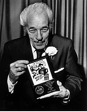 I. Stanford Jolley holds up his celebrity award at the third annual
Western Film Festival in Memphis, TN, in 1974. 