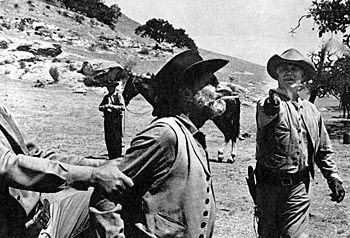 "Wagon Train"'s Frank McGrath trusts the expertise of Ward Bond to snap a cigarette out of his mouth with a bullwhip. 