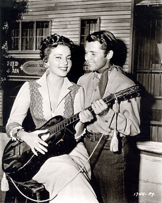 Band singer Abbe Lane and Audie Murphy between takes on “Ride Clear of Diablo” (‘53 Universal-International).