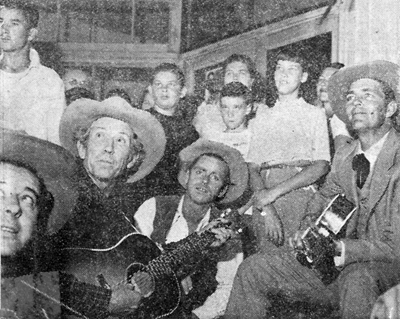 Dale Robertson (right) with (L-R) Ted Smile, Cactus Mack (with guitar) and Tim Nelson while on location in Tuolumne County, California filming an episode of "Tales of Wells Fargo". Fans gather behind them.