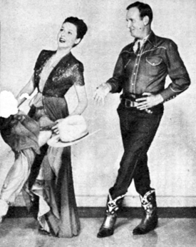 Gene Autry and leading lady Elena Verdugo practice a few dance steps.
