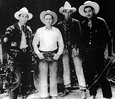 Cactus Mack (a cousin of Glenn Strange), Hoot Gibson, Skeeter Bill Robbins and Glenn Strange gather for Hoot's rodeo at Baker Ranch in 1934.