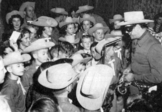 The Lone Ranger is swamped by fans in Austin, TX, in February '56.