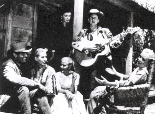 Taking a break on location for “The Dalton Girls” (‘57 United Artists) are (L-R) John Russell, Penny Edwards, Merry Anders, Sue George (standing), Johnny Western and Lisa Davis.