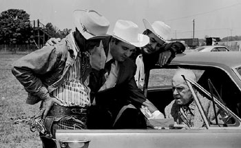 Ken Maynard studies the script with three other members of the cast of “Marshal of Windy Hollow”. (Photo courtesy Jerry Whittington.)