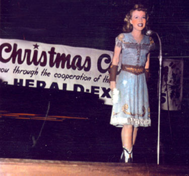 Carolina Cotton entertains troops on a USO tour sponsored in part (at least) by the Los Angeles HERALD-EXAMINER newspaper. (Photo courtesy Carolina’s daughter Sharon Marie.)