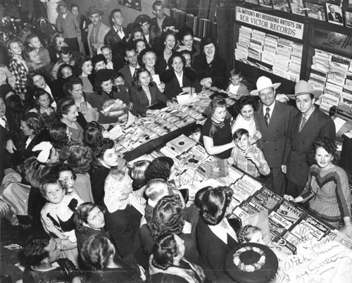 A crowd gathered at Dottie’s Music Department in McCrory’s Department Store on Texas Street in Shreveport, LA, in 1948 to greet Gene Autry and Johnny Bond. (Photo courtesy Edmond Smith of Little Rock, AR, seen standing with Gene.) 