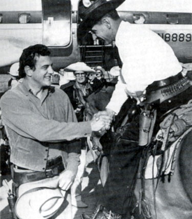 Deputy U. S. Marshal Raymon K. House greets “Gunsmoke” U.S. Marshal Matt Dillon (James Arness) at the dedication of Front Street in Dodge City, Kansas in 1958.