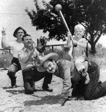 Little Johnny gets a lift from Ted French while Jimmy is catcher. Looks like “Cannonball” is calling two strikes on the kid.