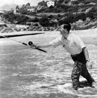 Jimmy casts his line into the Pacific waves.