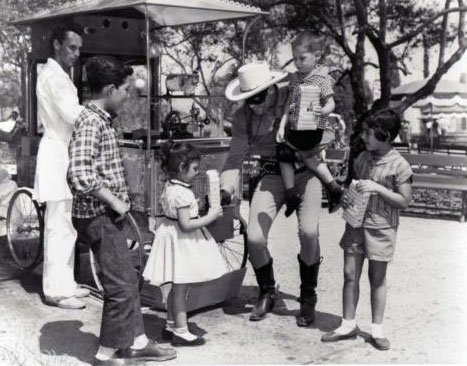 The Lone Ranger shares his popcorn with a group of young admirers.