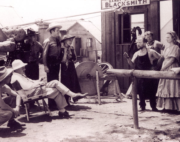 Robert North Bradbury directs Tom Keene and Betty Compson is a scene for “God’s Country and the Man” (‘37 Monogram). To the right are Billy Bletcher and Charlotte Henry.