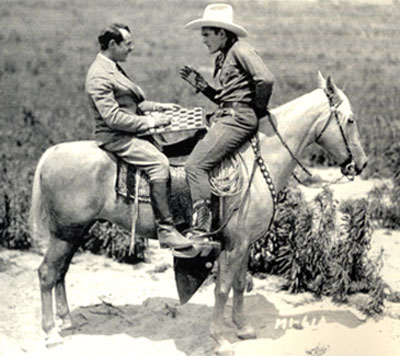 Tarzan remains still while director Al Rogell and Ken Maynard play a horseback game of checkers during a break from filming “Senor Daredevil” in 1926.