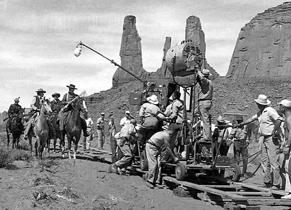 Filming a scene for “The Searchers” with John Wayne in front of the Three Sisters rock formation in Monument Valley. (Thanx to Jerry Whittington.)