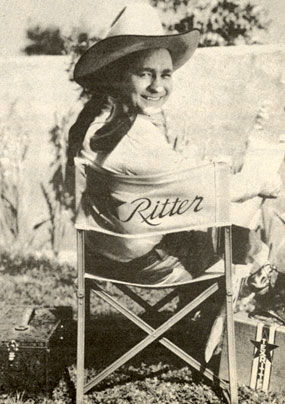 Monogram B-Western star Tex Ritter takes a break between scenes.