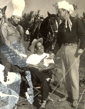 Apologies for the water damage on this photo which came from Russell Hayden's private files which we acquired several years ago. As a matter of fact, all the above material came from those files. This gag-publicity shot of Jackie Coogan (left) and Russell Hayden (right) was made during the filming of their "Cowboy G-Men" TV series. ('52-'53). We believe the man in the middle, being handed money by Coogan and Hayden, to be director Reg Browne. Can anyone confirm or deny?