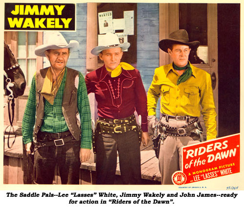 The Saddle Pals--Lee "Lasses" White, Jimmy Wakely and John James--ready for action in "Riders of the Dawn".